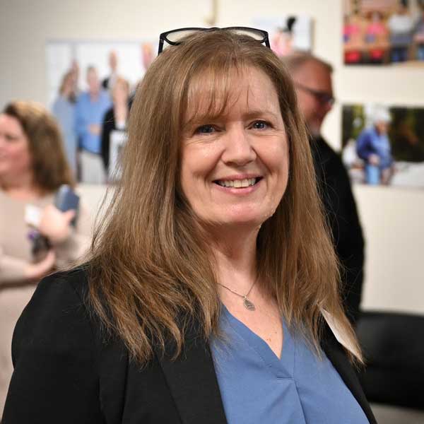 Jean wearing a blue top and black jacket